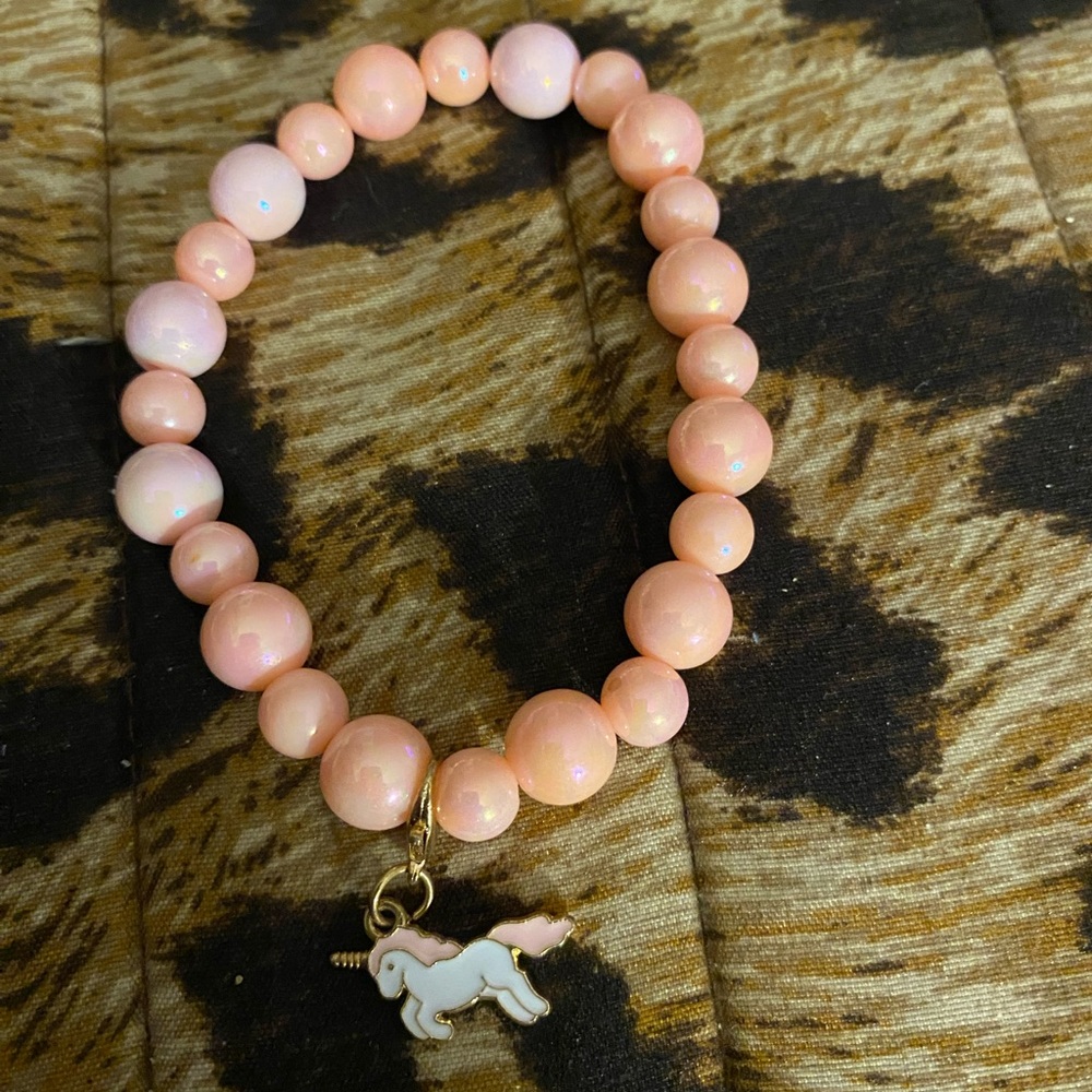 Handcrafted pink beaded bracelet with a unicorn charm